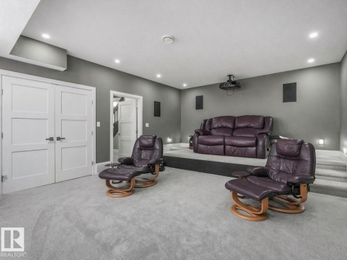 Recessed ceiling lighting, multi-level flooring, projector, built-in wall speakers, and double panel doors - 8927 120 Street Nw, Edmonton, AB - Indoor