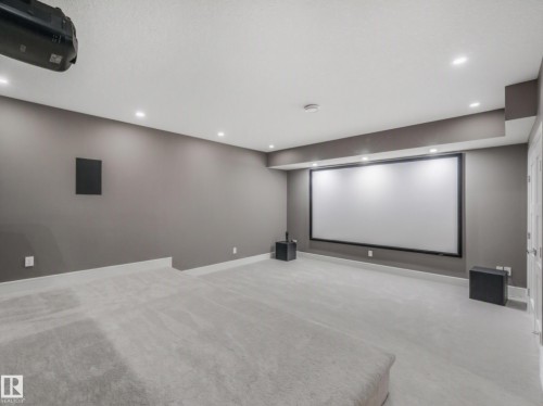 Dedicated media room with a large projection screen, recessed lighting, wall-mounted speakers, and plush carpet flooring - 8927 120 Street Nw, Edmonton, AB - Indoor Photo Showing Other Room