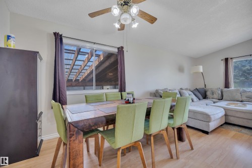 Dining area featuring light wood-finish flooring, a ceiling fan with light fixture, and a window providing natural light - 5411 44 Ave, Wetaskiwin, AB - Indoor Photo Showing Other Room