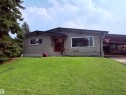 Mid-century modern residence featuring a brick and siding exterior, expansive front window, covered carport, and a well-maintained front lawn - 5411 44 Ave, Wetaskiwin, AB  - Outdoor 