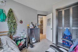 Bedroom featuring light gray wall paint and light-toned carpeting - 