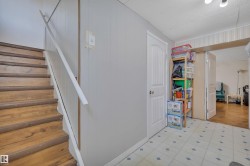 Wood-finish staircase with white handrail - 