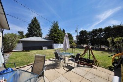 Paved patio area opening to a green lawn - 