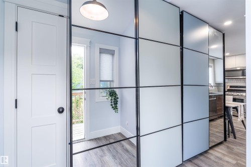 Modern room divider featuring frosted and mirrored panels with black framing - 10934 80 Avenue Nw, Edmonton, AB - Indoor Photo Showing Other Room