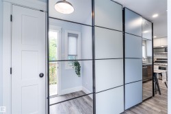 Modern room divider featuring frosted and mirrored panels with black framing - 