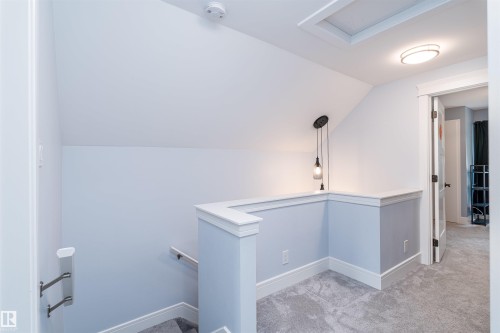 Carpeted landing with white baseboards and light blue walls - 10934 80 Avenue Nw, Edmonton, AB - Indoor