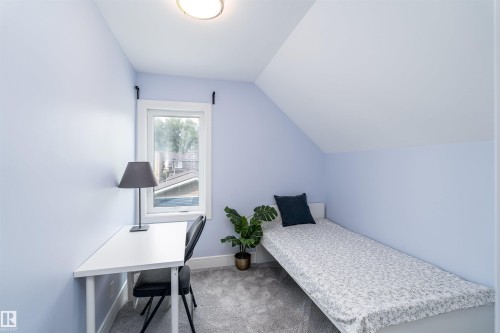 Room featuring light blue walls, a pitched ceiling, a white-framed window, and gray carpet flooring - 10934 80 Avenue Nw, Edmonton, AB - Indoor Photo Showing Bedroom
