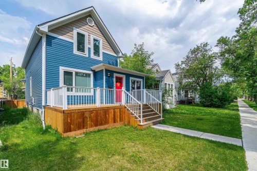 Two-story residence featuring blue horizontal siding and a contrasting brown gable accent - 10934 80 Avenue Nw, Edmonton, AB - Outdoor With Deck Patio Veranda