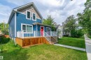 Two-story residence featuring blue horizontal siding and a contrasting brown gable accent - 10934 80 Avenue Nw, Edmonton, AB  - Outdoor With Deck Patio Veranda 