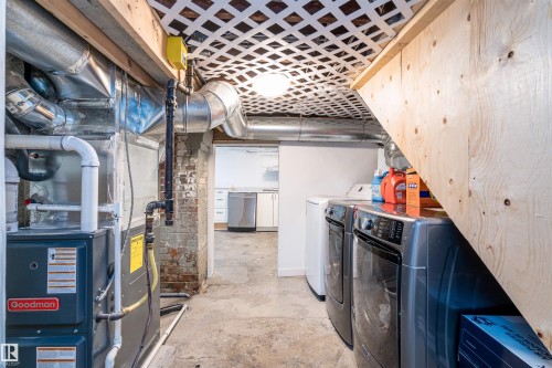 Basement utility area featuring a furnace, exposed ductwork, and a laundry setup with a washer and dryer - 10934 80 Avenue Nw, Edmonton, AB - Indoor Photo Showing Laundry Room