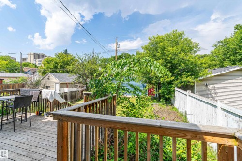 Expansive wood-decked patio with wood railings and a privacy fence - 10934 80 Avenue Nw, Edmonton, AB - Outdoor With Deck Patio Veranda