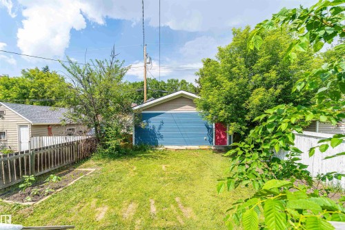 Rear detached structure featuring blue siding and a red side entry door - 10934 80 Avenue Nw, Edmonton, AB - Outdoor