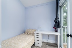 Room with light blue walls and wood-finish flooring - 