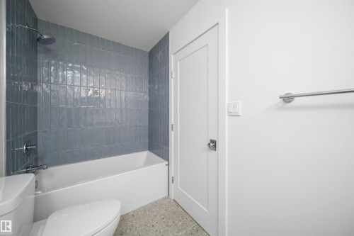 Soaking tub with a rain shower head, subway tile surround, and polished chrome fixtures - #A 12 Invermere Pl, St. Albert, AB - Indoor Photo Showing Bathroom