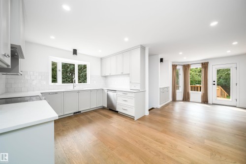 Modern kitchen featuring light gray cabinetry, white countertops, and subway tile backsplash - #A 12 Invermere Pl, St. Albert, AB - Indoor Photo Showing Kitchen