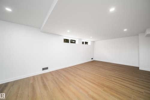 Recessed lighting, wood-finish flooring, white walls, and multiple windows - #A 12 Invermere Pl, St. Albert, AB - Indoor