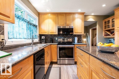 Kitchen featuring wood cabinetry and a diagonal tile backsplash - 14514 101 Avenue Nw, Edmonton, AB - Indoor Photo Showing Kitchen With Double Sink With Upgraded Kitchen
