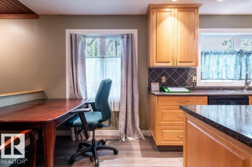 Kitchen area with wood-finish flooring and light wood cabinetry - 14514 101 Avenue Nw, Edmonton, AB - Indoor
