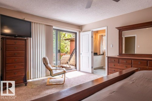 Carpeted interior space with direct access to an exterior balcony - 14514 101 Avenue Nw, Edmonton, AB - Indoor Photo Showing Bedroom