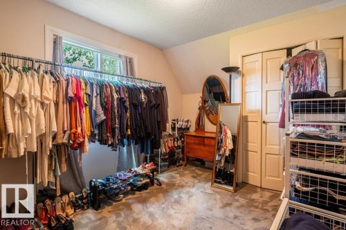 Room featuring a window with natural light, sloped ceiling, and carpet flooring - 14514 101 Avenue Nw, Edmonton, AB - Indoor