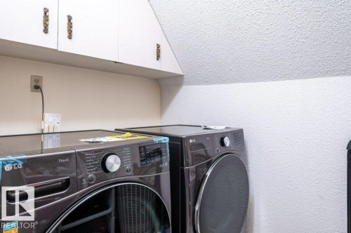 White upper cabinetry with decorative hardware - 14514 101 Avenue Nw, Edmonton, AB - Indoor Photo Showing Laundry Room