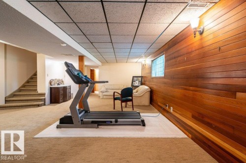 Finished lower level with paneled wood accent wall, recessed lighting, and drop ceiling - 14514 101 Avenue Nw, Edmonton, AB - Indoor Photo Showing Gym Room