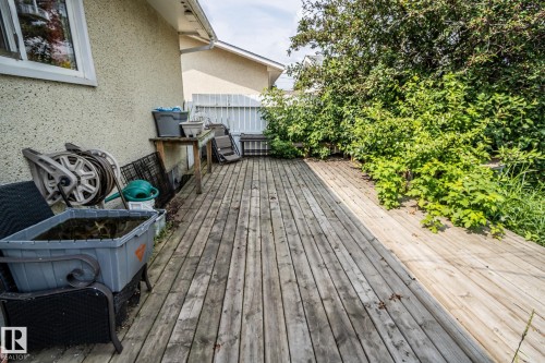 Outdoor wooden deck with perimeter landscaping and a privacy fence - 4322 49 Ave, St. Paul Town, AB - Outdoor With Deck Patio Veranda With Exterior