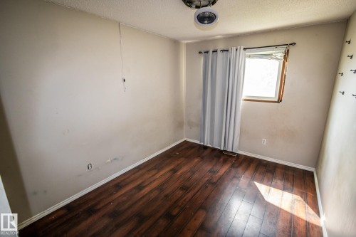 Wood-finish flooring - 4322 49 Ave, St. Paul Town, AB - Indoor Photo Showing Other Room