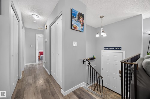 Bright hallway with wood-finish flooring, soft overhead lighting, and clean white trim throughout - 156 Clareview Road Nw, Edmonton, AB - Indoor Photo Showing Other Room
