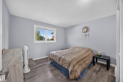 Wood-finish flooring, light grey wall paint, and a double-pane window - 156 Clareview Road Nw, Edmonton, AB - Indoor Photo Showing Bedroom