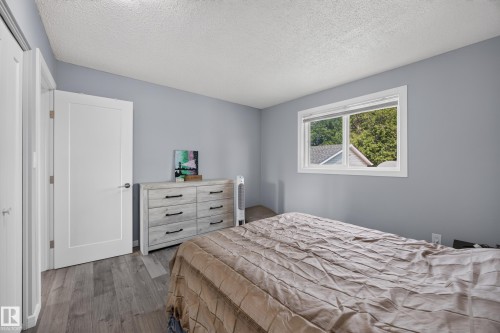 Wood-finish flooring, white trim, and a window with a sill - 156 Clareview Road Nw, Edmonton, AB - Indoor Photo Showing Bedroom