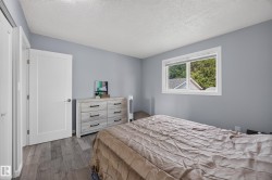 Wood-finish flooring, white trim, and a window with a sill - 