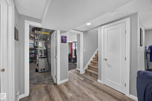 Wood-finish flooring throughout, smooth white doors with brushed nickel hardware, light gray wall tones, and recessed ceiling lighting - 156 Clareview Road Nw, Edmonton, AB - Indoor Photo Showing Other Room