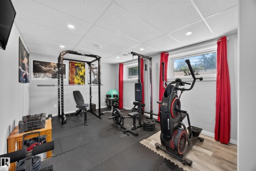 Recessed lighting, drop ceiling, gray painted walls, two windows, and wood-finish flooring - 156 Clareview Road Nw, Edmonton, AB - Indoor Photo Showing Gym Room