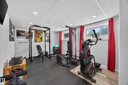 Recessed lighting, drop ceiling, gray painted walls, two windows, and wood-finish flooring - 