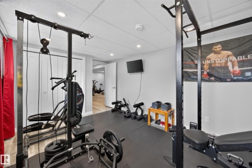 Dedicated fitness area featuring durable black rubber flooring, recessed lighting, and bright white walls - 156 Clareview Road Nw, Edmonton, AB - Indoor Photo Showing Gym Room