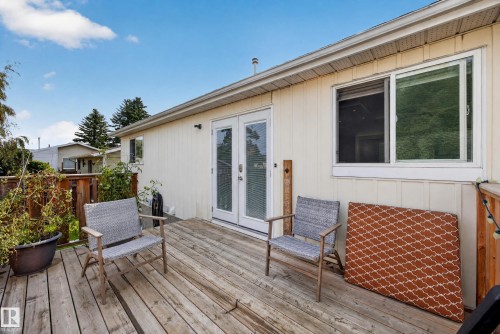 Exterior deck with wood decking, featuring double glass doors and a sliding window - 156 Clareview Road Nw, Edmonton, AB - Outdoor With Deck Patio Veranda With Exterior