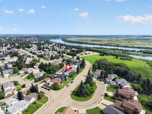 Residential neighborhood with mature trees, established properties, and a prominent river backdrop - 156 Clareview Road Nw, Edmonton, AB - Outdoor With View