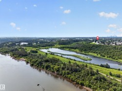 Expansive natural landscape featuring a prominent river, multiple serene lakes, dense mature trees, and open green spaces - 
