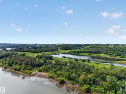 Expansive natural landscape featuring a prominent river, multiple waterways, and abundant mature trees - 