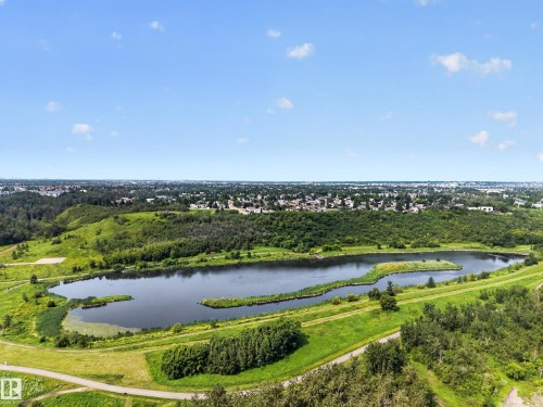 Expansive natural landscape featuring a serene lake, surrounding green spaces, and mature trees - 156 Clareview Road Nw, Edmonton, AB - Outdoor With View