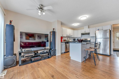 Hardwood-finish flooring throughout the open-concept living space - 3032 31 Avenue Nw, Edmonton, AB - Indoor Photo Showing Kitchen