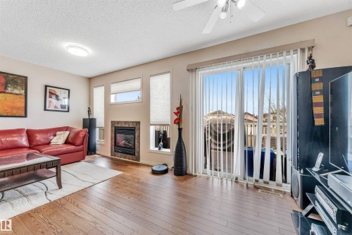 Hardwood-finish flooring, recessed lighting, and a ceiling fan - 3032 31 Avenue Nw, Edmonton, AB - Indoor Photo Showing Living Room With Fireplace