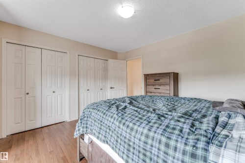 Wood-finish flooring throughout - 3032 31 Avenue Nw, Edmonton, AB - Indoor Photo Showing Bedroom