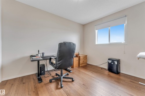 Wood-finish flooring throughout - 3032 31 Avenue Nw, Edmonton, AB - Indoor Photo Showing Office