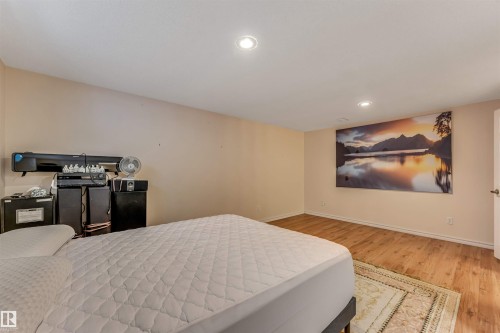 Wood-finish flooring with recessed lighting - 3032 31 Avenue Nw, Edmonton, AB - Indoor Photo Showing Bedroom