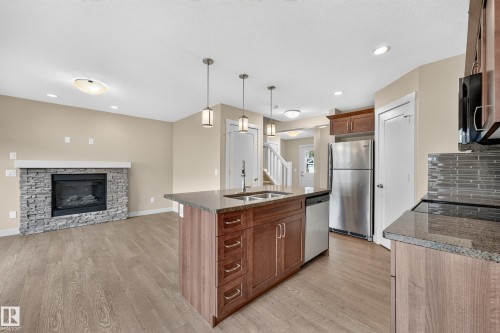 2730 Sparrow Place Nw, Edmonton, AB - Indoor Photo Showing Kitchen With Fireplace With Double Sink With Upgraded Kitchen