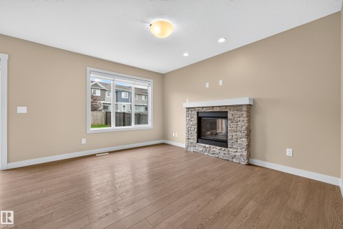 2730 Sparrow Place Nw, Edmonton, AB - Indoor Photo Showing Living Room With Fireplace