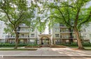 Multi-story building with a central arched entrance, individual balconies, and a fenced perimeter - #404 11103 84 Av Nw, Edmonton, AB  - Outdoor With Balcony With Facade 