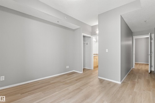 Wood-finish flooring throughout - #404 11103 84 Av Nw, Edmonton, AB - Indoor Photo Showing Other Room
